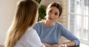 Woman discussing possible signs of infection after an abortion with a healthcare professional.